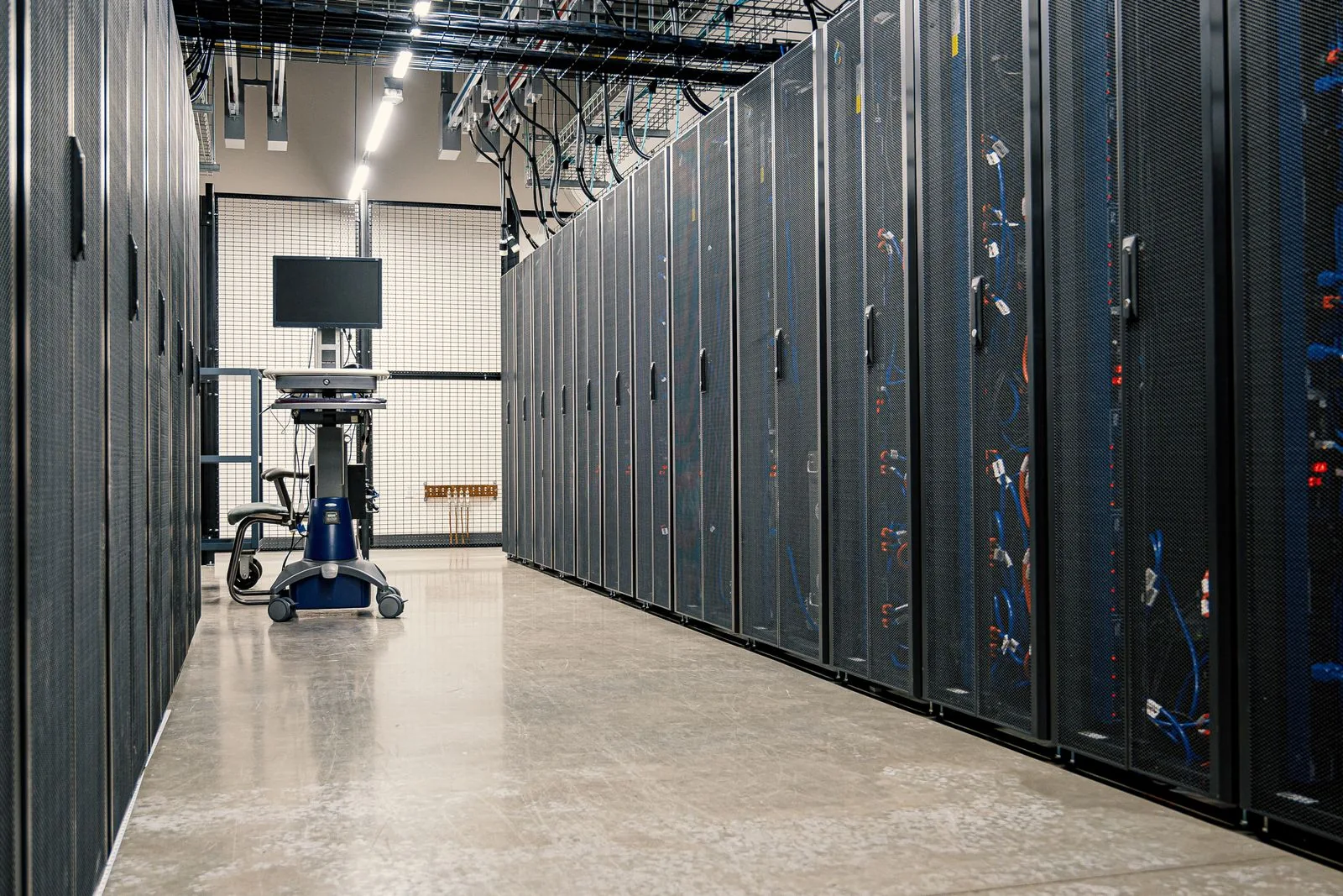 Data center server racks and overhead infrastructure — contextual image
